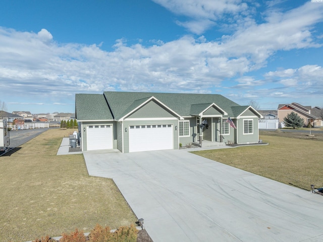 ranch-style house with roof with shingles, a front yard, fence, a garage, and driveway