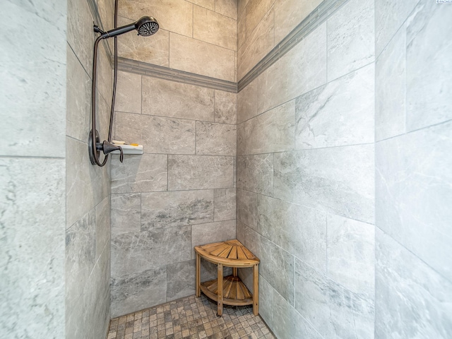 bathroom with tiled shower