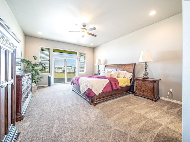 carpeted bedroom featuring access to outside, multiple windows, baseboards, and recessed lighting