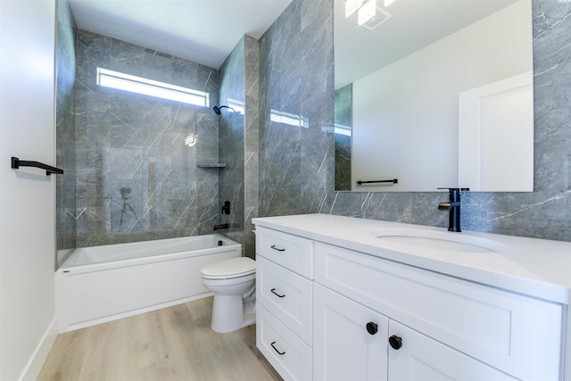 1557 Livorno Ave, Richland, WA 99352 - bathroom featuring vanity, toilet, shower / bathing tub combination, decorative backsplash, and wood finished floors