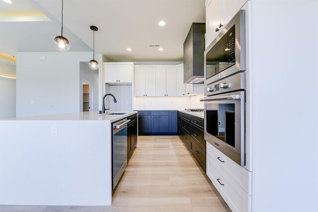 1557 Livorno Ave, Richland, WA 99352 - kitchen with light wood-style floors, pendant lighting, white cabinets, appliances with stainless steel finishes, and a sink