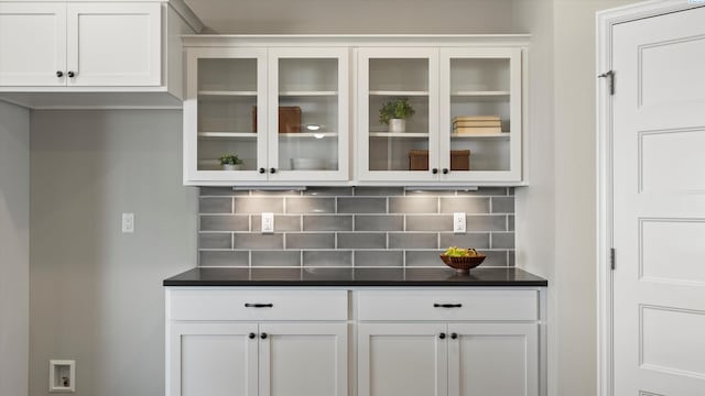 6564 W 38th Ave, Kennewick, WA 99338 - kitchen with dark countertops, glass insert cabinets, decorative backsplash, and white cabinetry