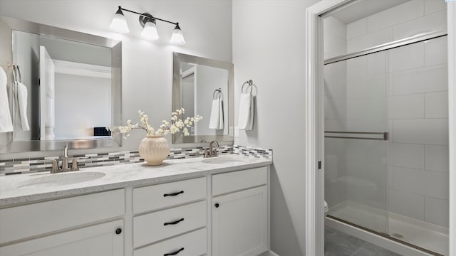 6564 W 38th Ave, Kennewick, WA 99338 - full bathroom with double vanity, a shower stall, and tasteful backsplash