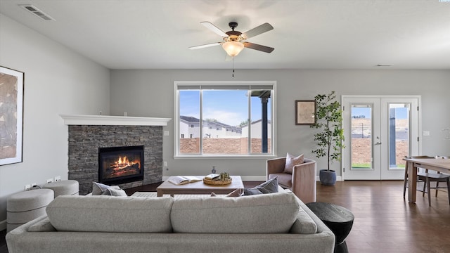 6564 W 38th Ave, Kennewick, WA 99338 - living room featuring dark wood-style flooring, a stone fireplace, french doors, and a ceiling fan