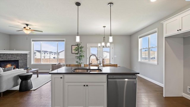 6564 W 38th Ave, Kennewick, WA 99338 - kitchen featuring stainless steel dishwasher, dark wood finished floors, open floor plan, a stone fireplace, and white cabinets