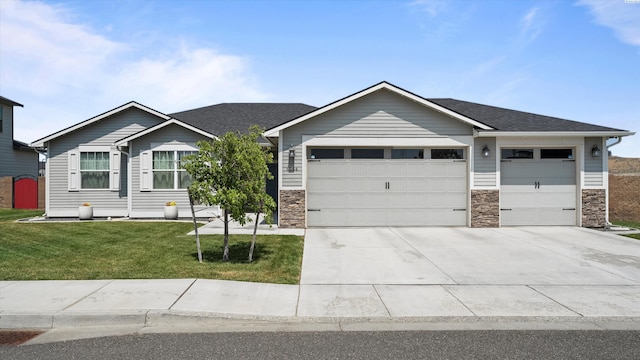 6564 W 38th Ave, Kennewick, WA 99338 - view of front facade with an attached garage, driveway, a front lawn, stone siding, and roof with shingles