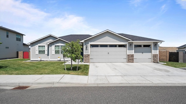 6564 W 38th Ave, Kennewick, WA 99338 - view of front of home featuring an attached garage, driveway, stone siding, and roof with shingles