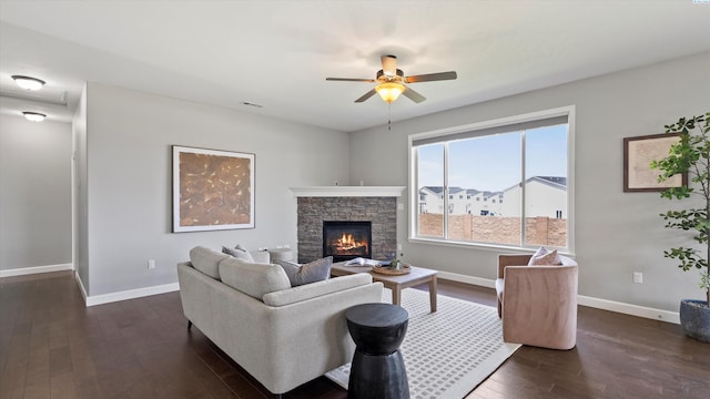 6564 W 38th Ave, Kennewick, WA 99338 - living room featuring dark wood-style floors, ceiling fan, and a stone fireplace