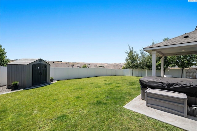 10389 W 17th Pl, Kennewick, WA 99338 - fenced backyard featuring a storage unit and a hot tub