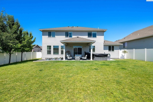 10389 W 17th Pl, Kennewick, WA 99338 - back of house with a hot tub, a patio, a fenced backyard, and a shingled roof