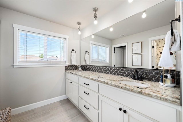 10389 W 17th Pl, Kennewick, WA 99338 - bathroom featuring decorative backsplash and double vanity