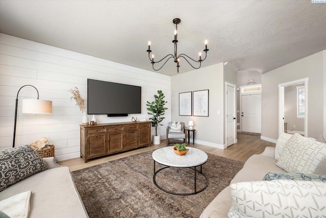 10389 W 17th Pl, Kennewick, WA 99338 - living area featuring wood finished floors, a chandelier, and wooden walls
