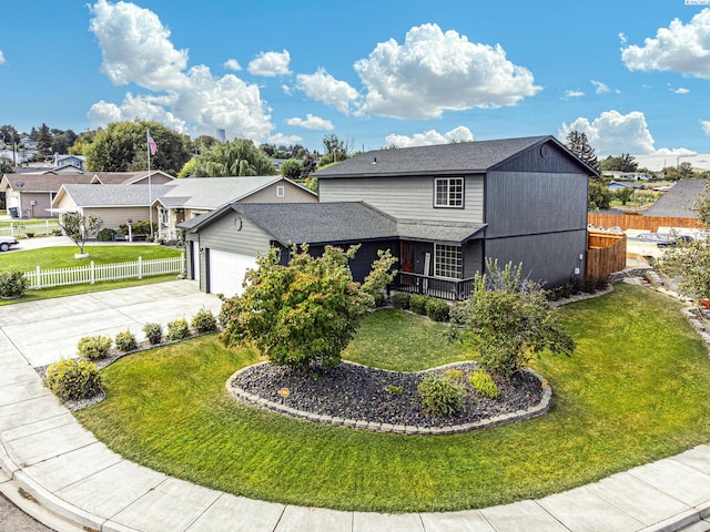 view of property with a garage and a front lawn