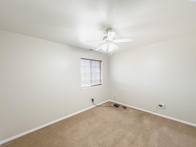 unfurnished room featuring light colored carpet and ceiling fan