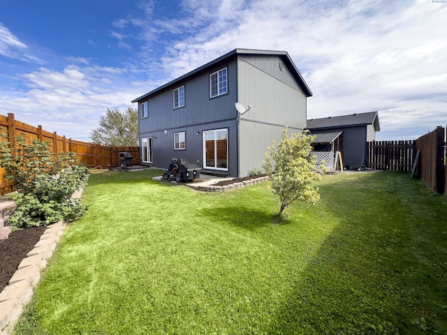 rear view of house featuring a yard and a patio area