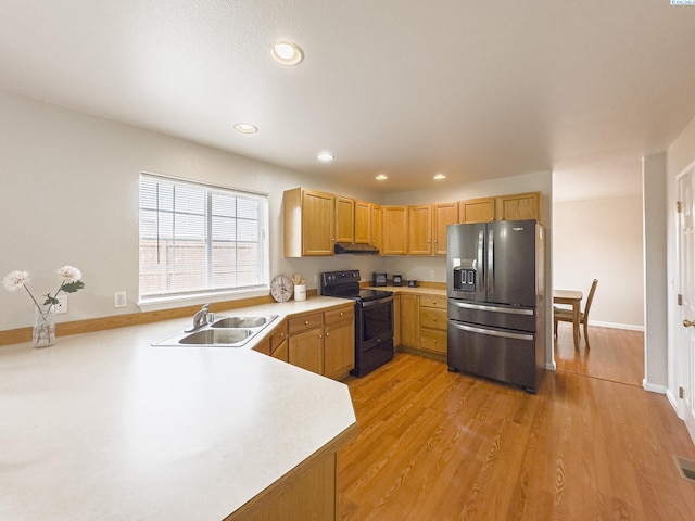 kitchen with sink, stainless steel fridge with ice dispenser, black electric range, and light wood-type flooring