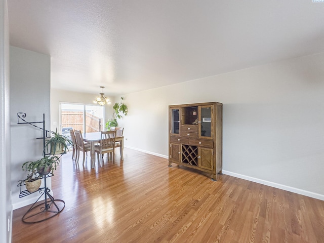 dining room featuring light hardwood / wood-style floors and a notable chandelier