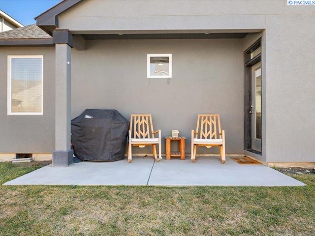 exterior space with a patio area, stucco siding, and a yard