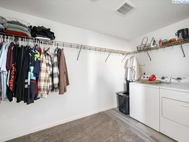 spacious closet with visible vents and separate washer and dryer