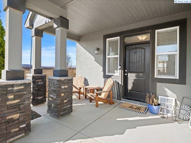 view of exterior entry featuring stucco siding