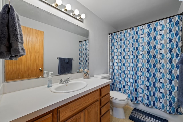 bathroom with vanity, curtained shower, and toilet