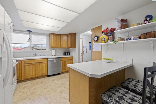 kitchen featuring pendant lighting, sink, white refrigerator, stainless steel dishwasher, and kitchen peninsula