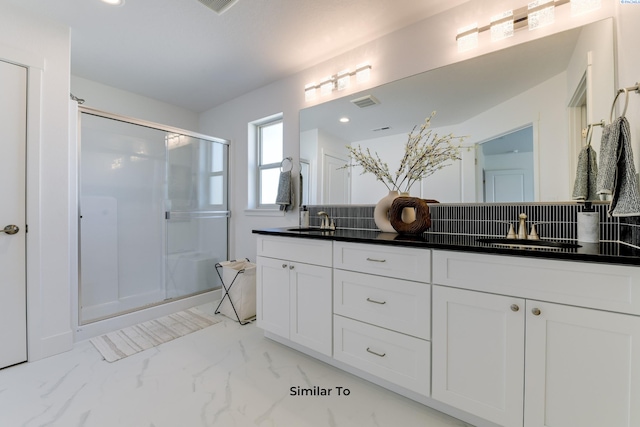 6905 Rd 108, Pasco, WA 99301 - bathroom featuring double vanity, marble look tile flooring, a stall shower, and backsplash