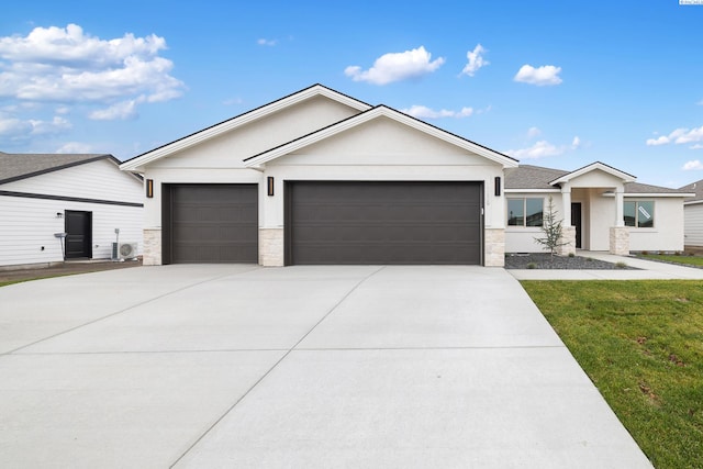 10409 Kokanee Dr, Pasco, WA 99301 - ranch-style house featuring stone siding, a garage, driveway, a front lawn, and stucco siding