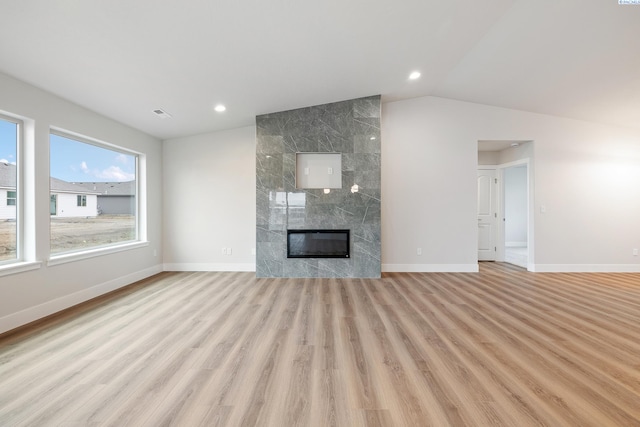 10409 Kokanee Dr, Pasco, WA 99301 - unfurnished living room featuring light wood finished floors, a fireplace, lofted ceiling, and recessed lighting