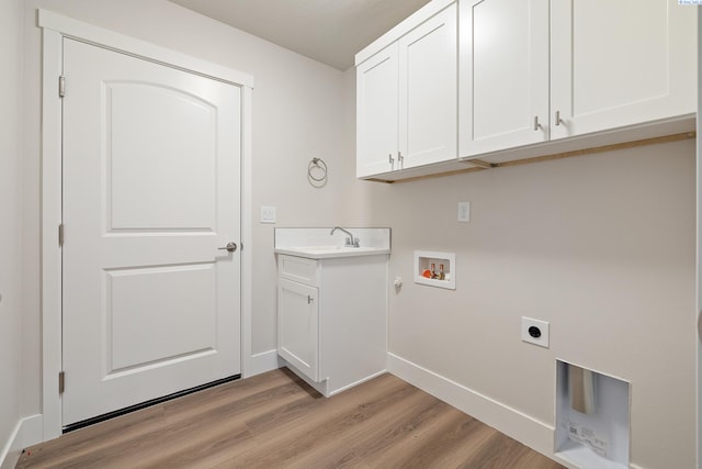 10409 Kokanee Dr, Pasco, WA 99301 - washroom with hookup for an electric dryer, washer hookup, light wood finished floors, cabinet space, and gas dryer hookup