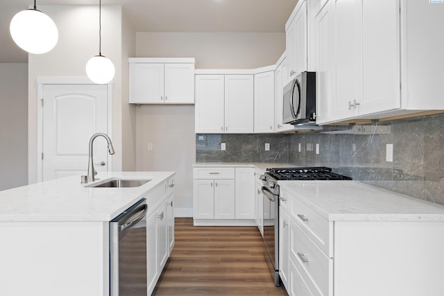 10409 Kokanee Dr, Pasco, WA 99301 - kitchen with stainless steel appliances, dark wood finished floors, white cabinetry, and tasteful backsplash