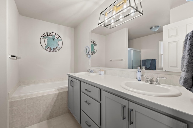 98702 E Brooklyn Dr, Kennewick, WA 99338 - bathroom with double vanity, a bath, a shower stall, and tile patterned flooring