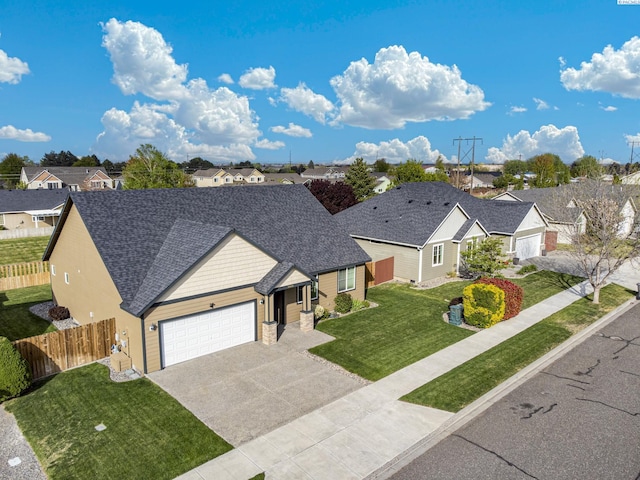 ranch-style house with concrete driveway, an attached garage, fence, and a residential view