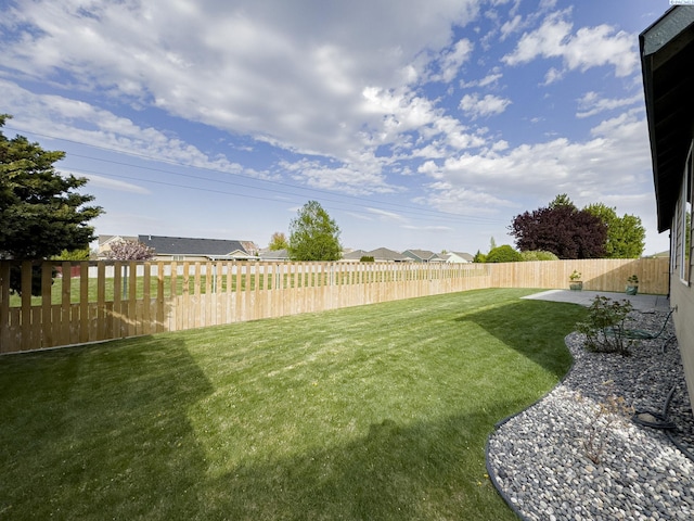 view of yard with a fenced backyard and a patio