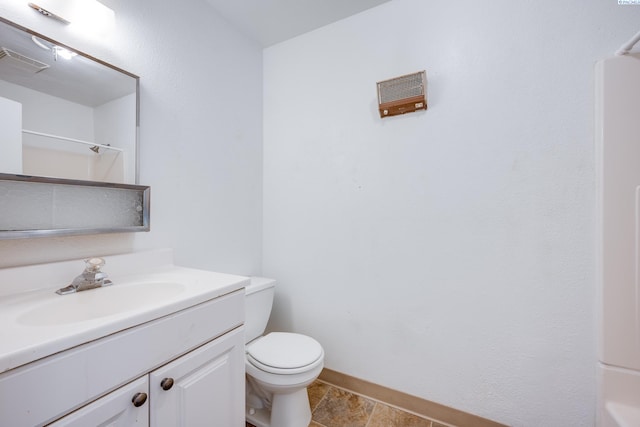 bathroom with vanity, toilet, baseboards, a shower, and visible vents