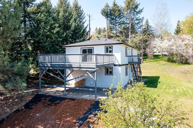 back of property featuring stairway, a patio area, a yard, and a deck