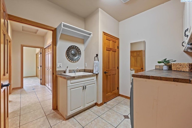 100 S Nevada St, Kennewick, WA 99336 - laundry room with light tile patterned floors and attic access