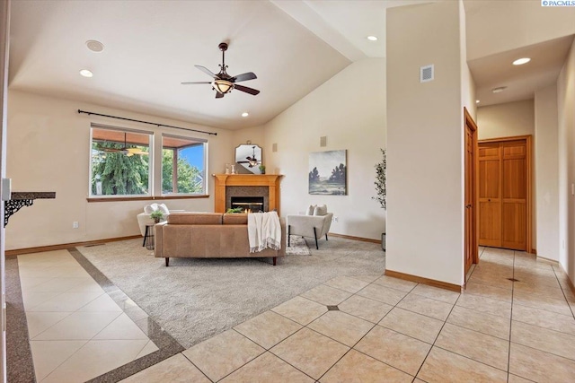 100 S Nevada St, Kennewick, WA 99336 - living area with light tile patterned floors, a glass covered fireplace, a ceiling fan, recessed lighting, and light colored carpet