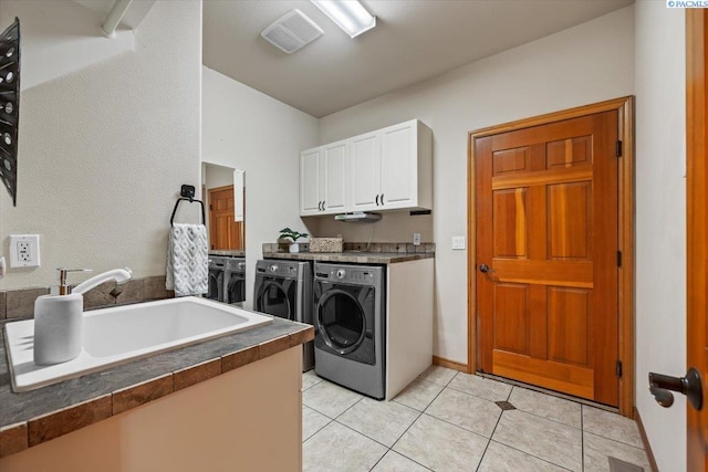100 S Nevada St, Kennewick, WA 99336 - washroom featuring cabinet space, washer and clothes dryer, and light tile patterned flooring