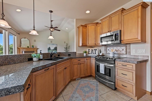 100 S Nevada St, Kennewick, WA 99336 - kitchen with stainless steel appliances, light tile patterned floors, lofted ceiling, ceiling fan, and hanging light fixtures