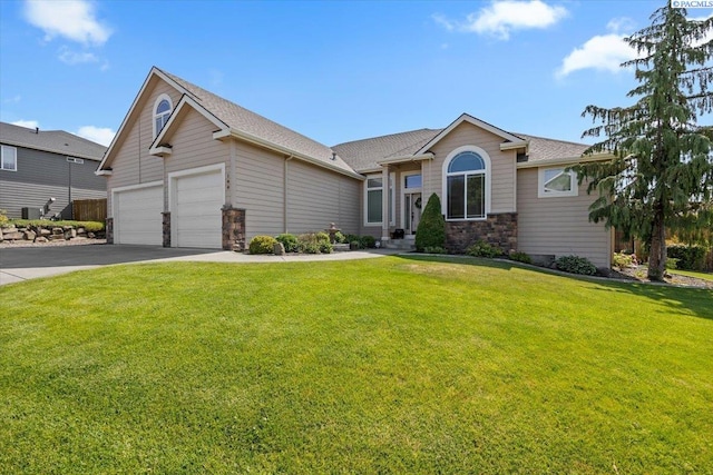 100 S Nevada St, Kennewick, WA 99336 - ranch-style home with a front yard, asphalt driveway, stone siding, an attached garage, and roof with shingles