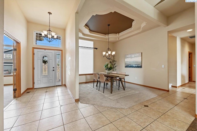100 S Nevada St, Kennewick, WA 99336 - foyer featuring a chandelier, light tile patterned floors, light carpet, and a tray ceiling