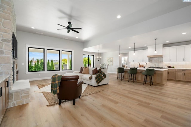 671 Cortona Way, Richland, WA 99352 - living room featuring a stone fireplace, recessed lighting, light wood finished floors, and ceiling fan