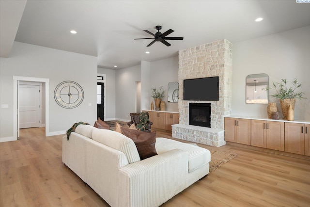 671 Cortona Way, Richland, WA 99352 - living room featuring light wood-style floors, ceiling fan, a stone fireplace, and recessed lighting