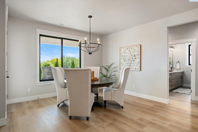 671 Cortona Way, Richland, WA 99352 - dining area featuring a chandelier and light wood-style floors
