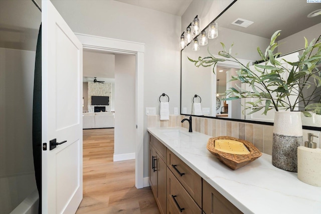 671 Cortona Way, Richland, WA 99352 - bathroom featuring decorative backsplash, double vanity, wood finished floors, and ceiling fan