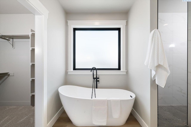 671 Cortona Way, Richland, WA 99352 - bathroom featuring a spacious closet, a freestanding tub, and tiled shower