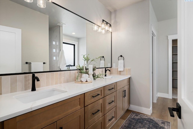 671 Cortona Way, Richland, WA 99352 - bathroom with double vanity, tasteful backsplash, and wood finished floors