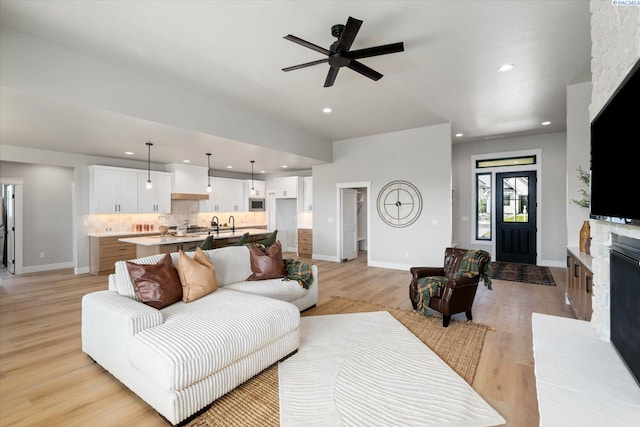 671 Cortona Way, Richland, WA 99352 - living room featuring a fireplace with raised hearth, light wood-style flooring, recessed lighting, and ceiling fan