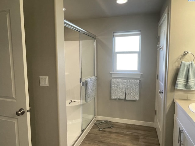 230 Ladera St, Prosser, WA 99350 - bathroom with baseboards, recessed lighting, vanity, wood finished floors, and a stall shower